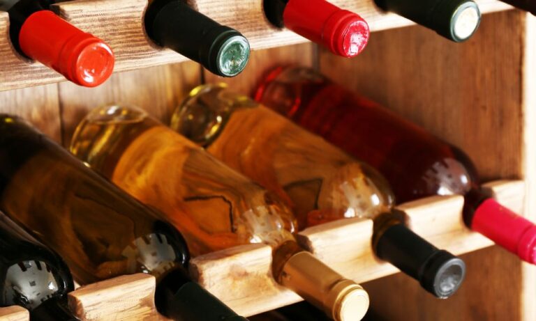 wine bottles on rack inside Houston custom glass wine room