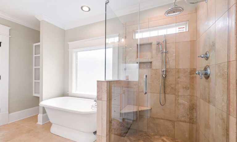 modern bathroom with frameless glass showers and beige tiling